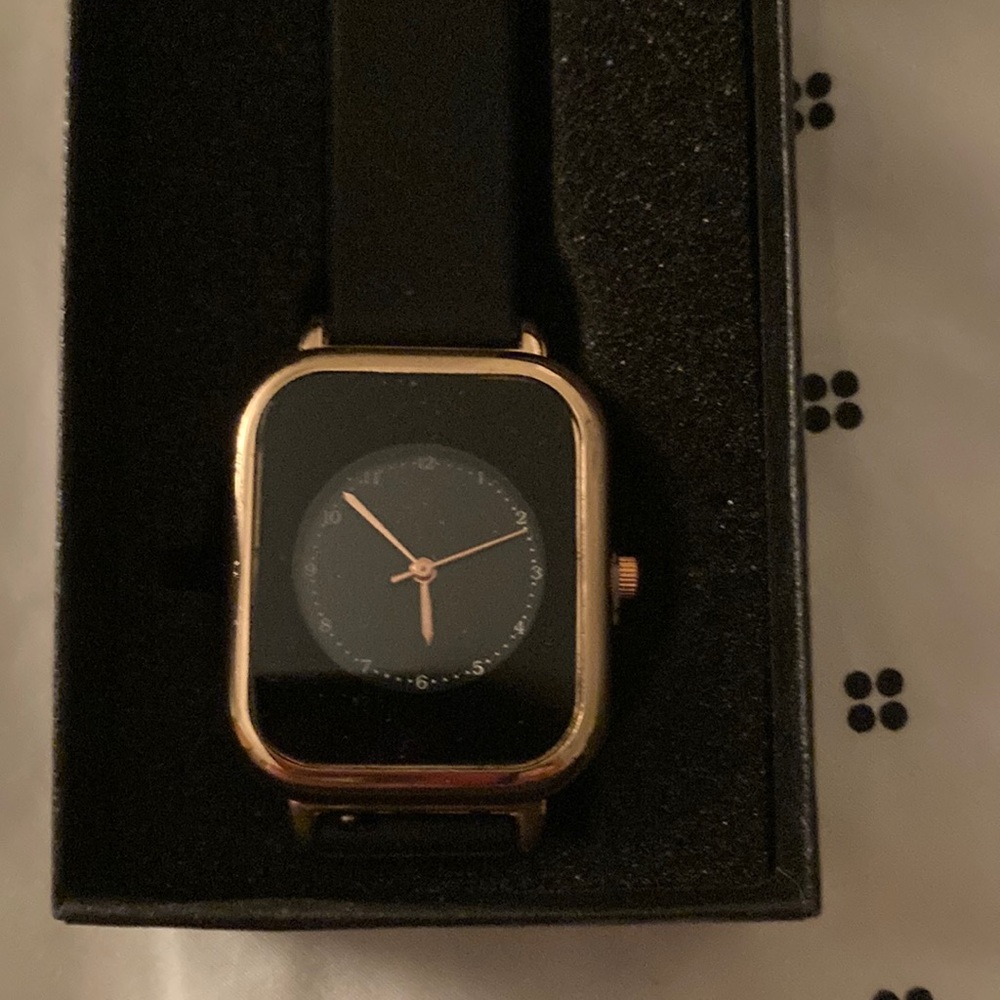 Womens wristwatch. Black and gold face. Band is rubber material.